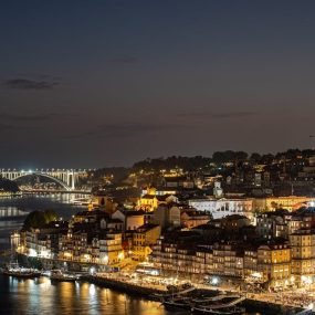 A breathtaking night view of Porto, Portugal, showcasing illuminated cityscapes along the Douro River.