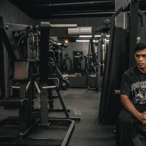 A man sitting on a bench in a gym